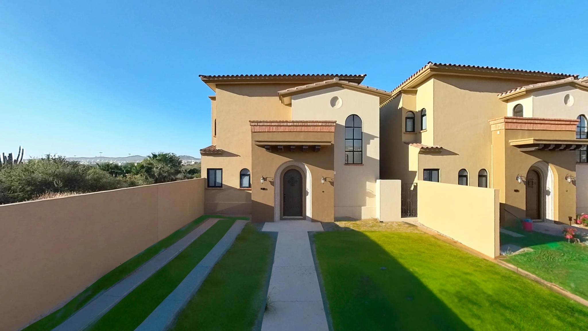 Front view of the Mavila villa prototype with landscaped garden