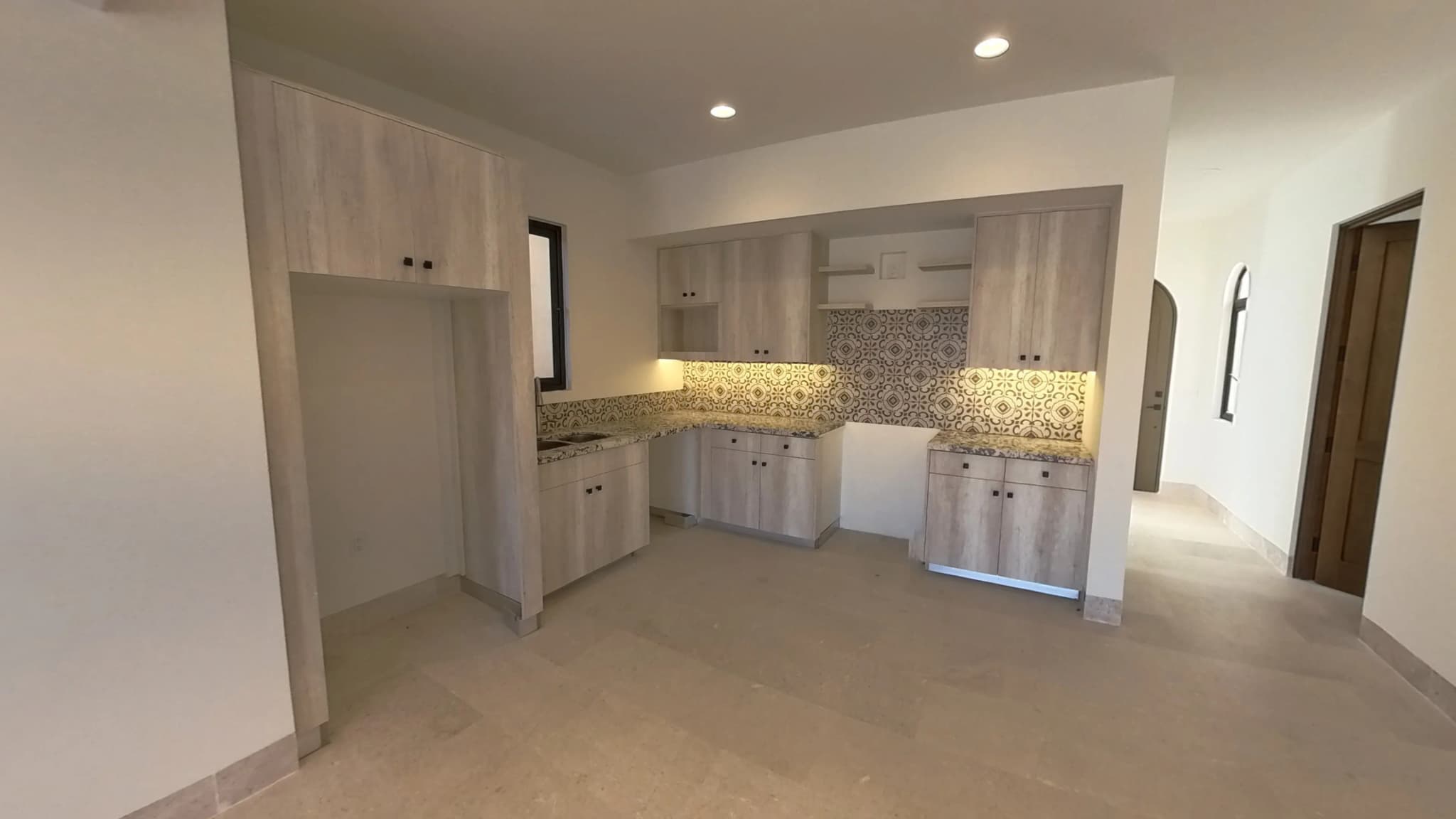 Spacious kitchen area with built-in cabinetry in the Mavila villa prototype