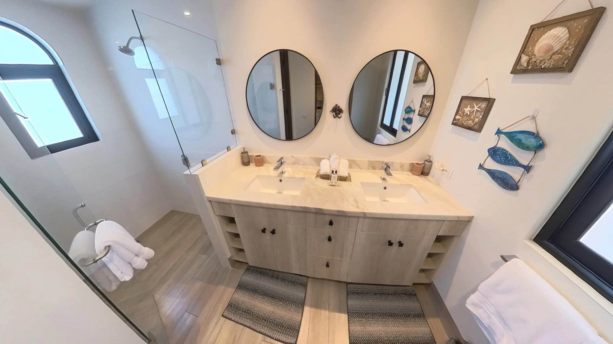Modern bathroom with double vanity and elegant decor in the Mavila 2-bedroom prototype